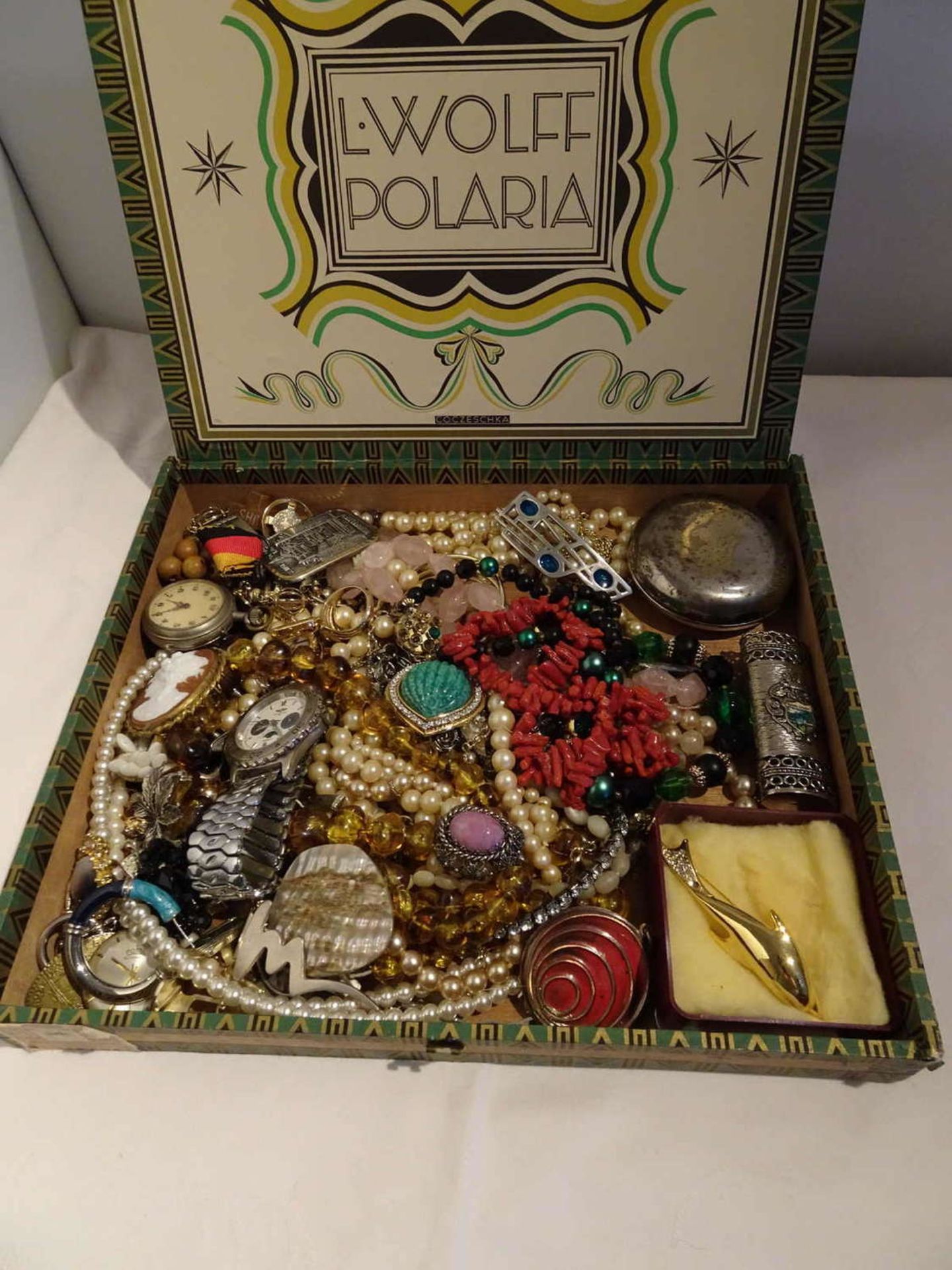Lot of costume jewelry in cigar box. Please visit!