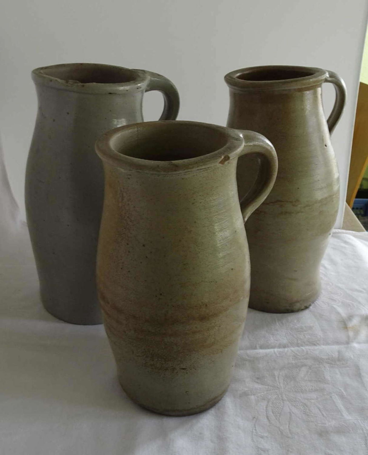 3 old buttermilk jugs, different models. Partly with chip