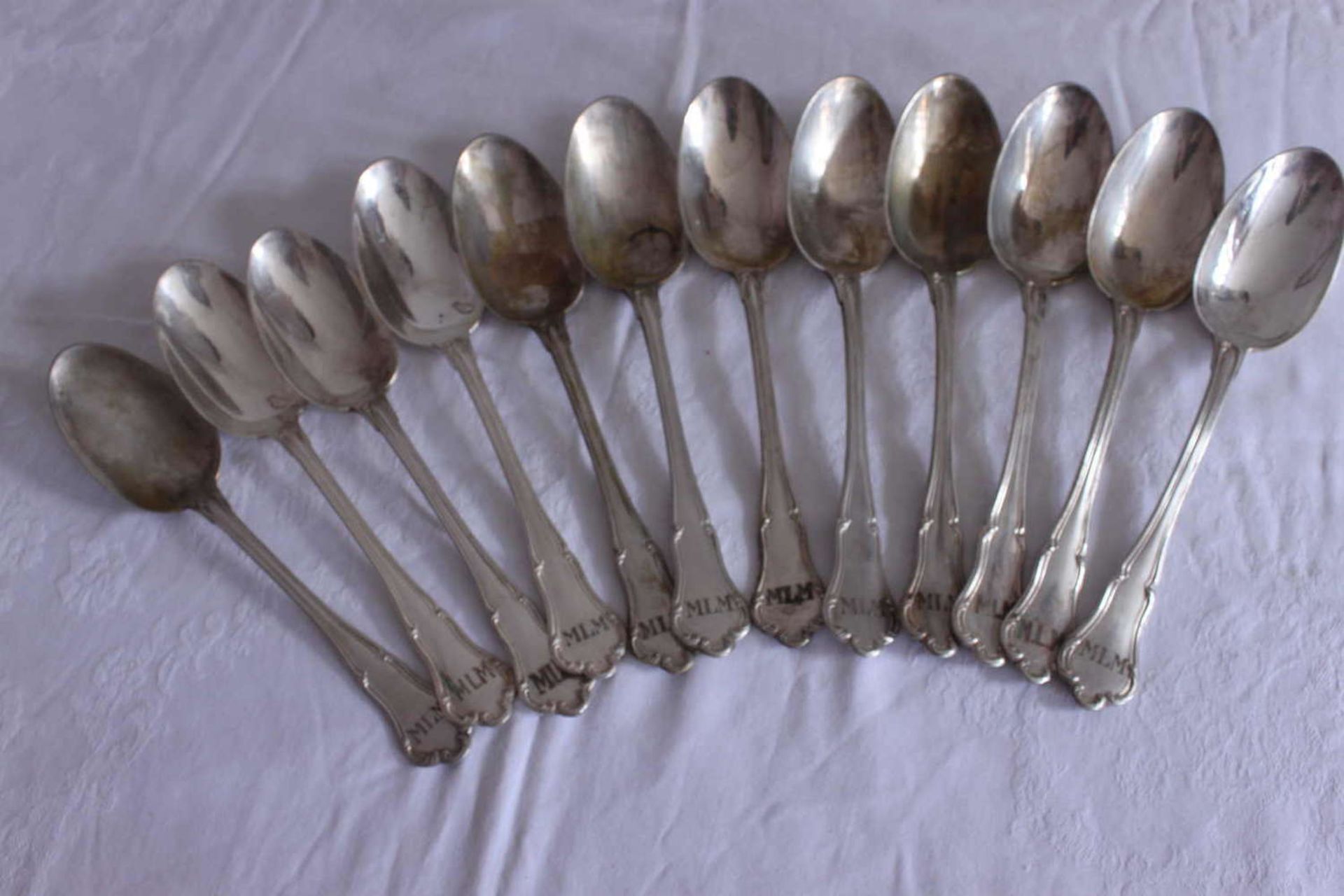 12 soup spoons, 800 silver, same series, with monogram "MLM". Total weight about 700 gr