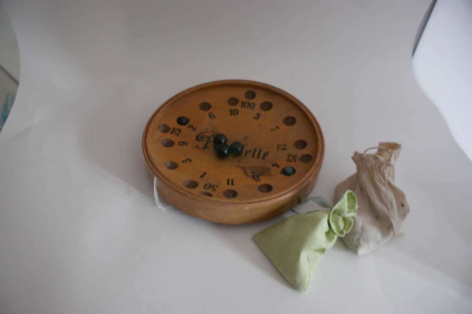 Roulette wooden game, circa 1900, with 15 balls. Diameter about 25 cm. Recorded, age-appropriate