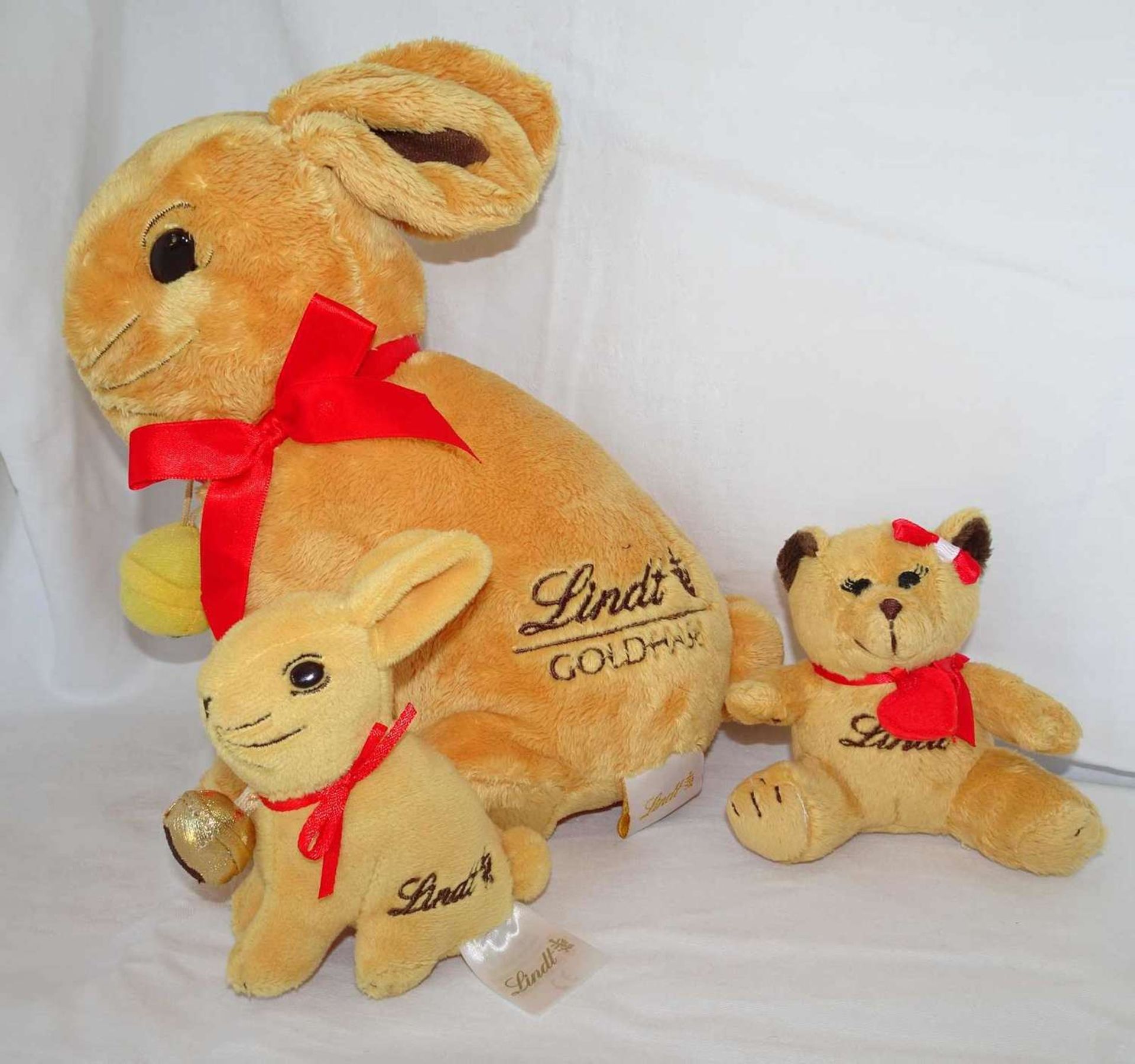 Soft toy set by Lindt, including 1 large rabbit, 1 small rabbit and 1 teddy. Very good condition.