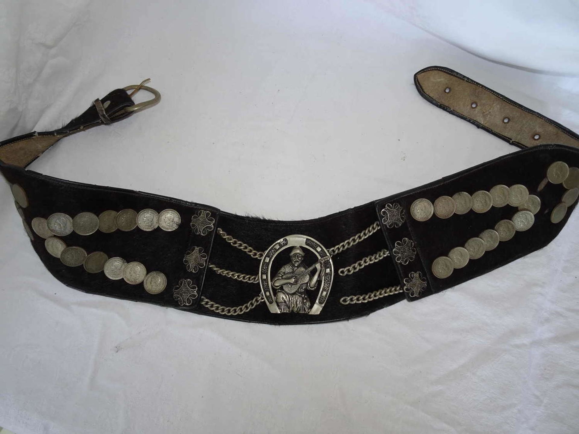 1 older Gaucho belt from Argentina, original from the period, equipped with coins. The focus is on