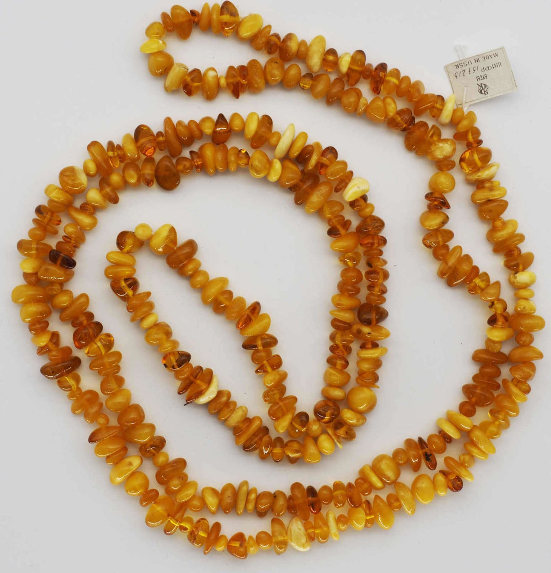 Very long fancy amber necklace, as well as honey amber, with original Russian label. Length