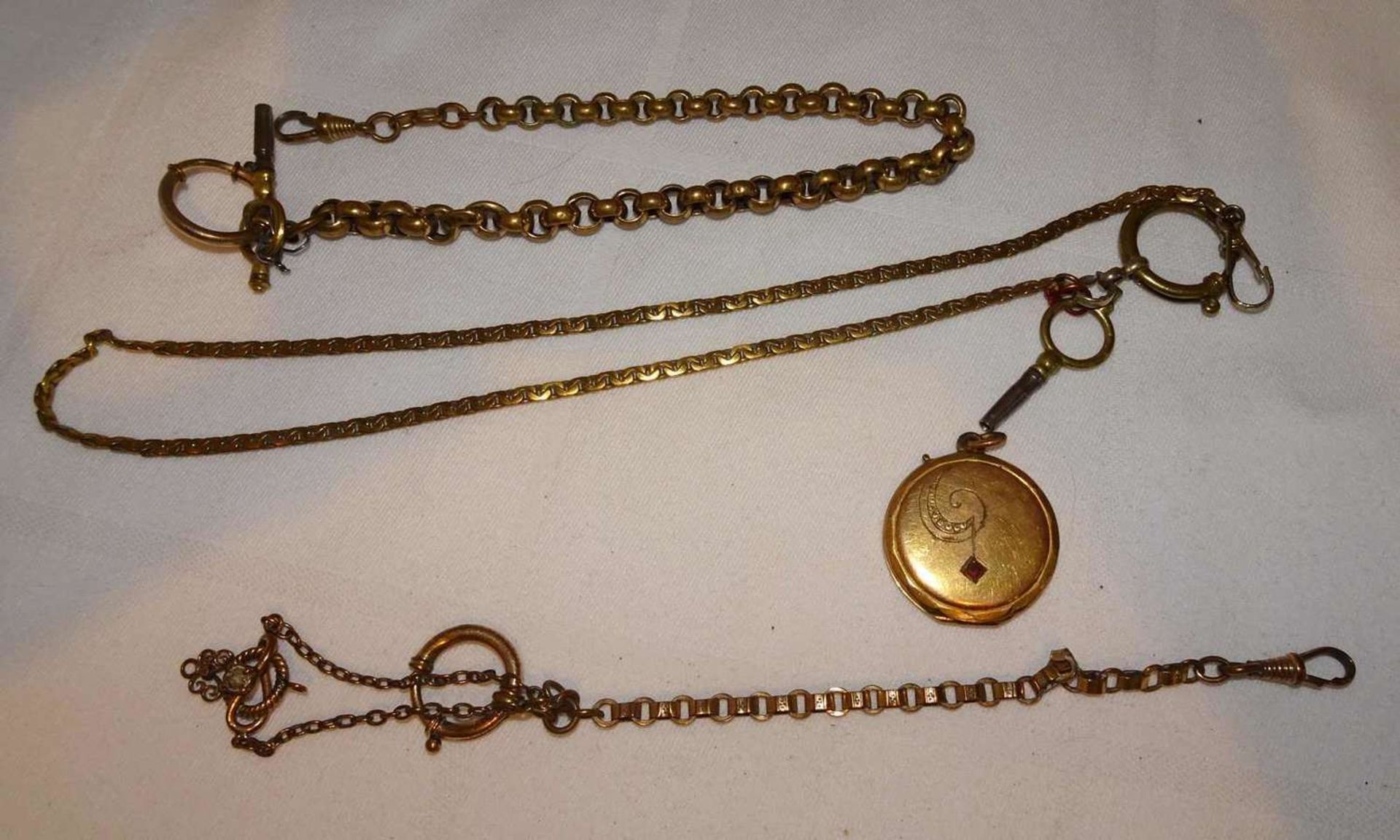 3 Uhrenketten, sowie ein Jugendstil Medaillon 3 watch chains and an Art Nouveau medallion