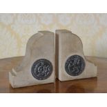 A pair of stone bookends by repute stone from the Houses of Parliament, each with applied white