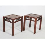 A pair of Chinese dark wood jardiniere stands, Qing Dynasty, the square panelled tops above open