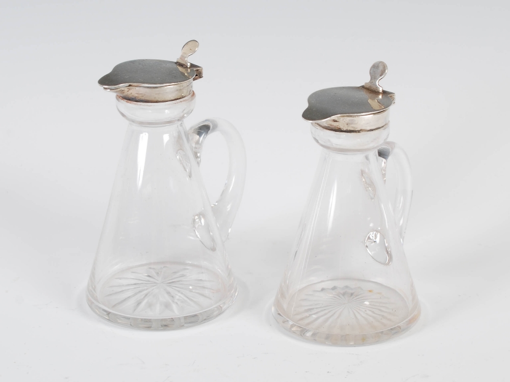 A near pair of George V silver mounted clear glass whisky noggins, Birmingham, 1917, makers mark