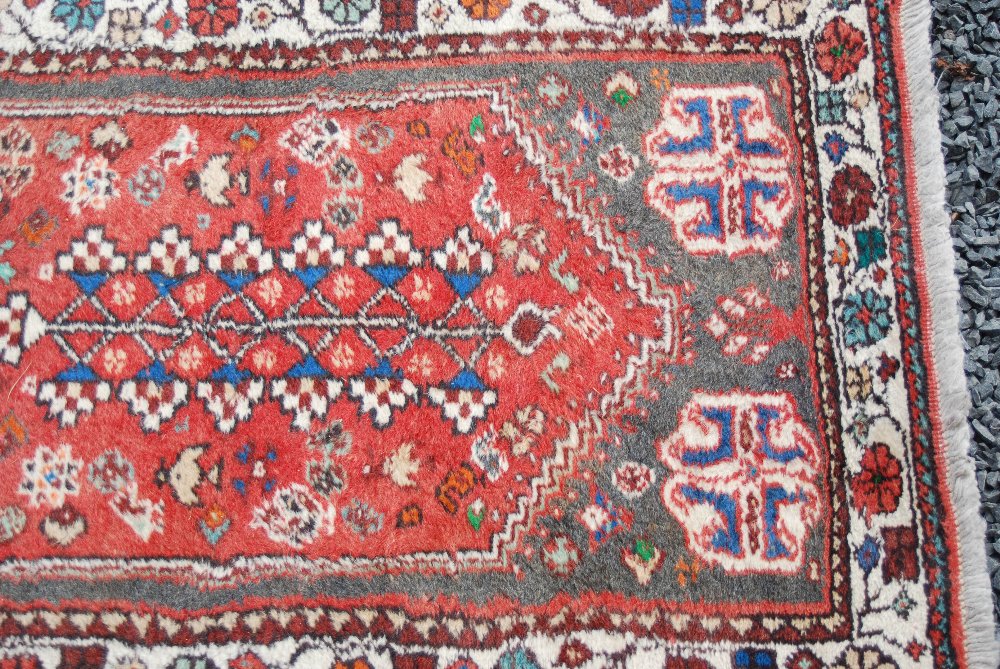 A Persian runner, 20th century, the rectangular madder ground centred with an octagonal shaped - Image 3 of 4