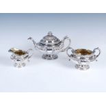 A George IV silver three piece tea set, Edinburgh, 1826, makers mark of AE, circular with part