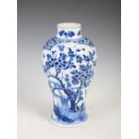 A Chinese porcelain blue and white jar, Qing Dynasty, decorated with two shaped panels enclosing