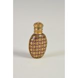 A late 19th century yellow metal overlaid ruby glass scent bottle and stopper, the hinged yellow
