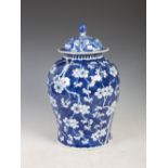 A Chinese porcelain blue and white jar and matched cover, Qing Dynasty, decorated with prunus