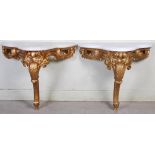 A pair of Victorian style giltwood and white marble console tables, the shaped marble tops above