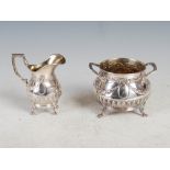 A late 19th/ early 20th century Continental silver twin handled sugar bowl and matching cream jug,