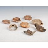 Antiquities- A collection of eight Ancient Roman terracotta oil lamps, comprising; one plain oil