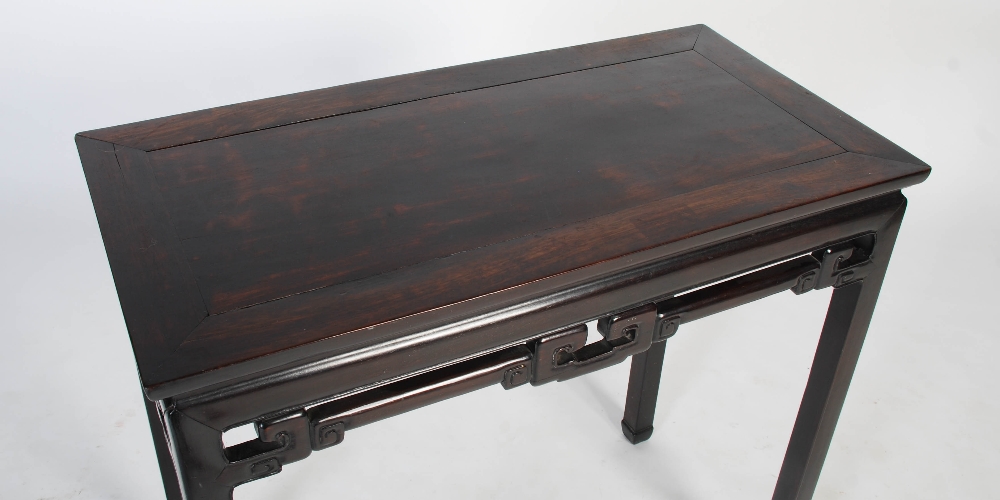 A Chinese dark wood rectangular table, Qing Dynasty, the rectangular panelled top above a plain - Image 2 of 8