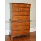 An 18th century walnut chest on chest, the rectangular top with a moulded cornice and flat top,