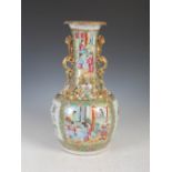 A Chinese porcelain famille rose Canton bottle vase, Qing Dynasty, decorated with rectangular shaped