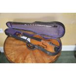 A late 19th century violin, in fitted case with bow, 59cm long.