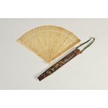 A fine and rare Chinese ivory fan together with its original silk sleeve/ case, Qing Dynasty, the
