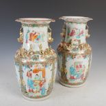 A pair of Chinese porcelain famille rose Canton vases, Qing Dynasty, decorated with panels of