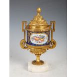 A 19th century ormolu and marble mounted cobalt blue ground porcelain twin handled urn and cover,