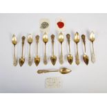 A set of twelve Continental white metal teaspoons and a vintage tin containing a red wax and a