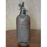 An Art Deco white metal mounted soda siphon by Sparklets Ltd., London, 34cm high.