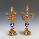 A pair of late 19th century French porcelain and gilt metal mounted four light candelabra, the