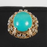A yellow and white metal turquoise and diamond cocktail ring, mid 20th century, centred with an oval