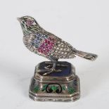 A 19th century Indian white metal, enamel and gem set model of a bird, modelled standing on a square