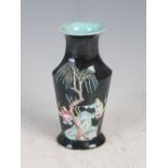 A small Chinese porcelain black ground vase, Qing Dynasty, decorated in relief with rockwork, palm