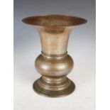 A Chinese bronze vase, with flared rim and horizontal ribbed detail, 25cm high.