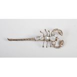 An early 20th century Russian white metal and moonstone scorpion brooch, 7.5cm long, in original