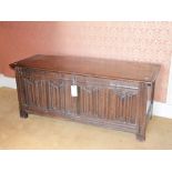 An 18th/19th century oak coffer, the hinged rectangular top with moulded edge, above a quadruple