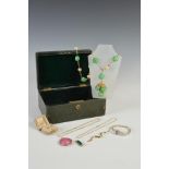 A late 19th/ early 10th century green leather jewellery box and contents, to include, a