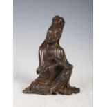 A Chinese bronze figure of Guanyin, modelled sitting holding a scroll in her right hand, 11cm high x