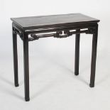 A Chinese dark wood rectangular table, Qing Dynasty, the rectangular panelled top above a plain