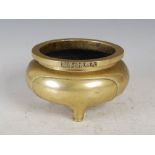 A Chinese bronze censer, Qing Dynasty, bearing six character Xuande mark, of circular form raised on