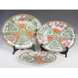 A set of three Chinese porcelain famille rose Canton graduated meat plates, late 19th/early 20th