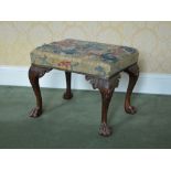 A late 19th/early 20th century George III style mahogany needlework upholstered stool, the