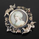 An 18th century white metal mounted portrait miniature of a Lady mounted as a brooch, the circular