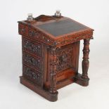 A Victorian oak Davenport, the rectangular top with two division letter rack and two facet cut glass