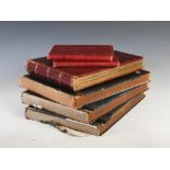 Four early 20th century leather bound photograph albums and two leather bound note books documenting