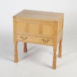 Manner of Mouseman - an oak sewing table, the hinged rectangular top opening to a plain recess