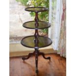 A 19th century mahogany graduated three tier revolving dumb waiter, with chevron inlaid detail on