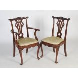 A set of eight early 20th century mahogany dining chairs in the George III style, the shaped top