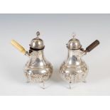 A pair of Victorian silver chocolate pots, London, 1890, makers mark of AB over HWW, one with turned