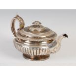 A George IV silver teapot, London, 1826, makers mark rubbed, circular shaped with part gadrooned