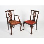 A set of fourteen George III style mahogany dining chairs, the foliate and scroll carved top rails